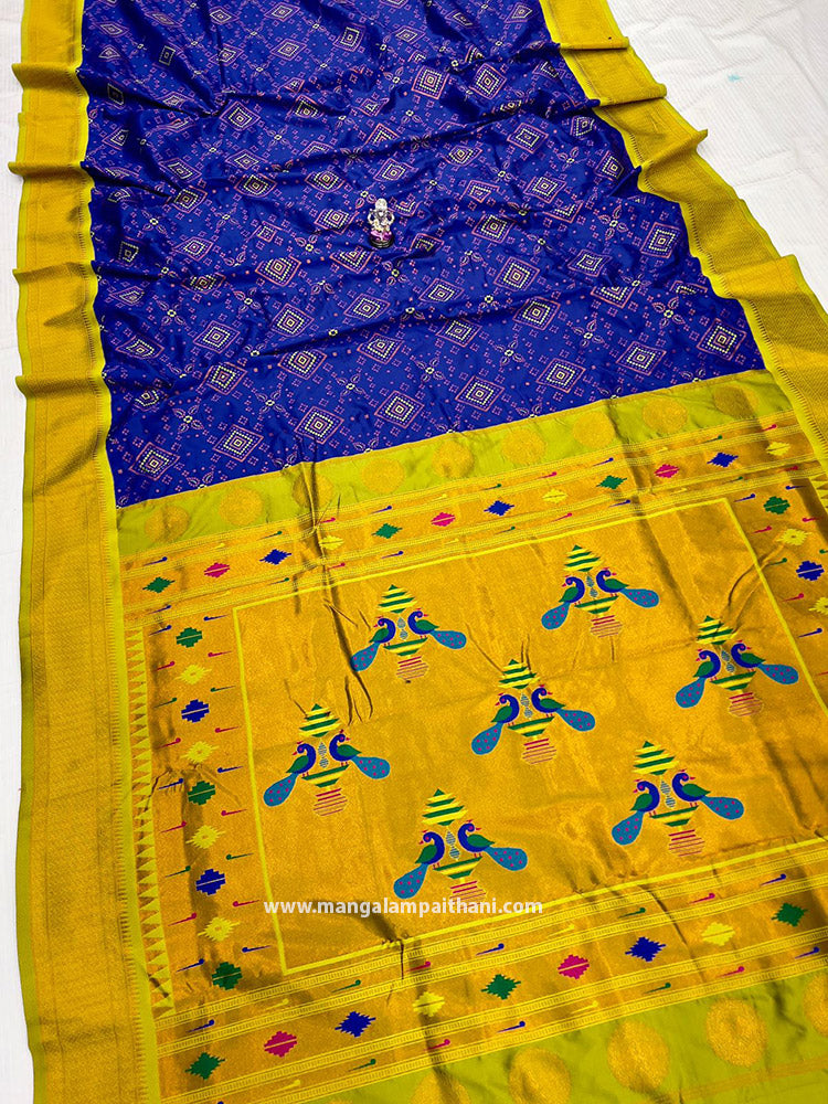 A Yashika Bandhani Paithani saree with a geometric pattern in blue and yellow colors, with a decorative border.