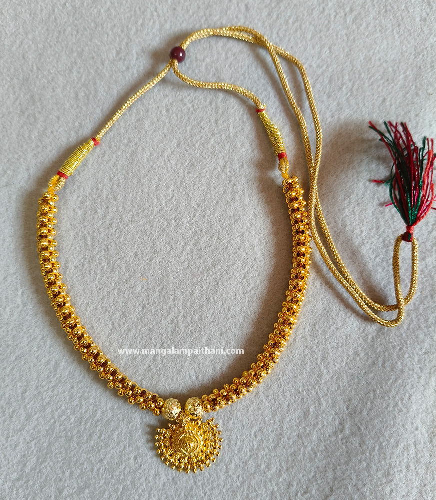 Gold plated choker necklace with a floral design on the pendant.