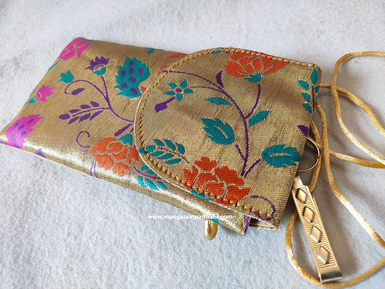multicolored floral Paithani mobile pouch with a zipper and a wristlet strap